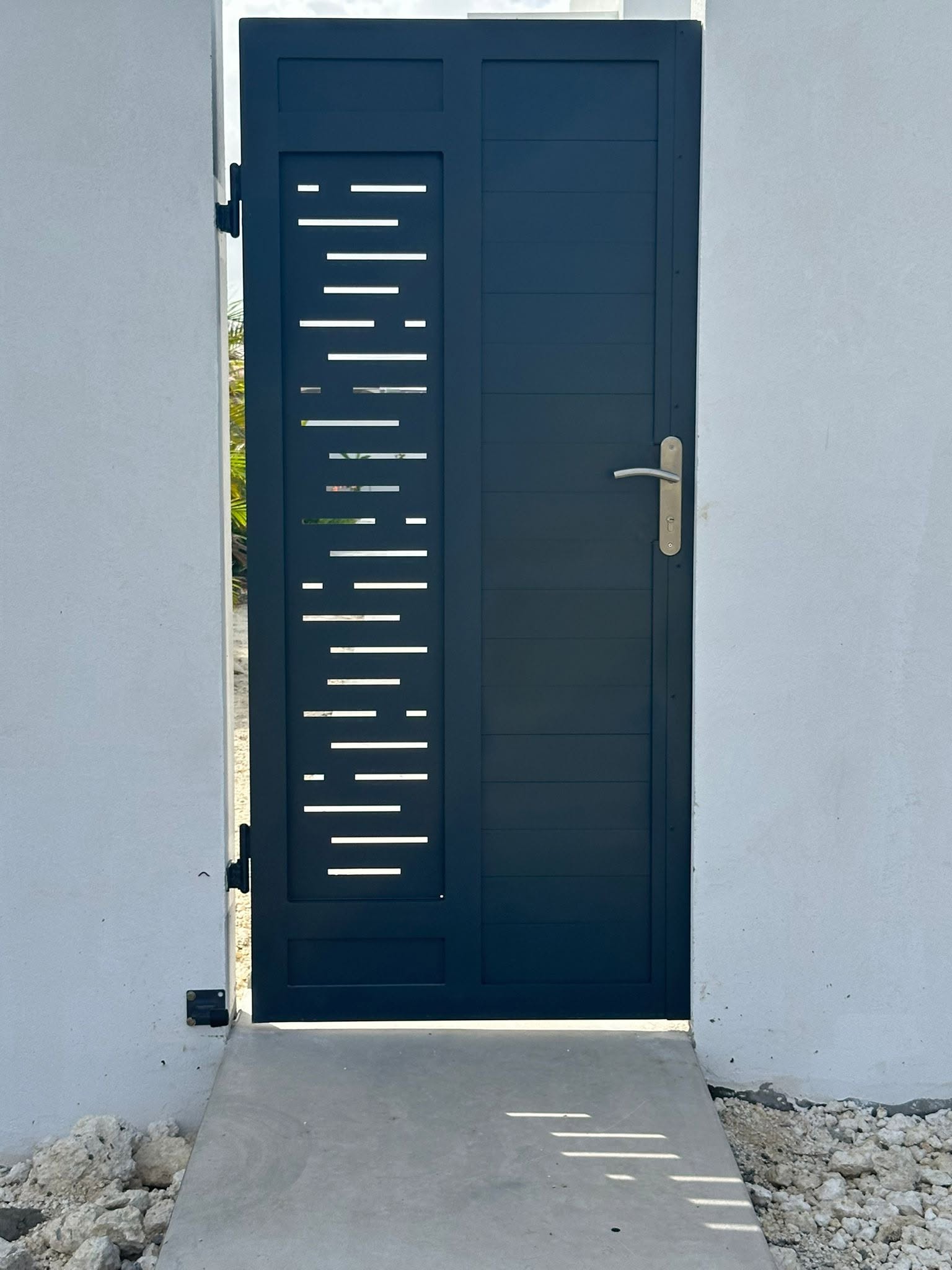 Laser-cut aluminium gate with slotted pattern